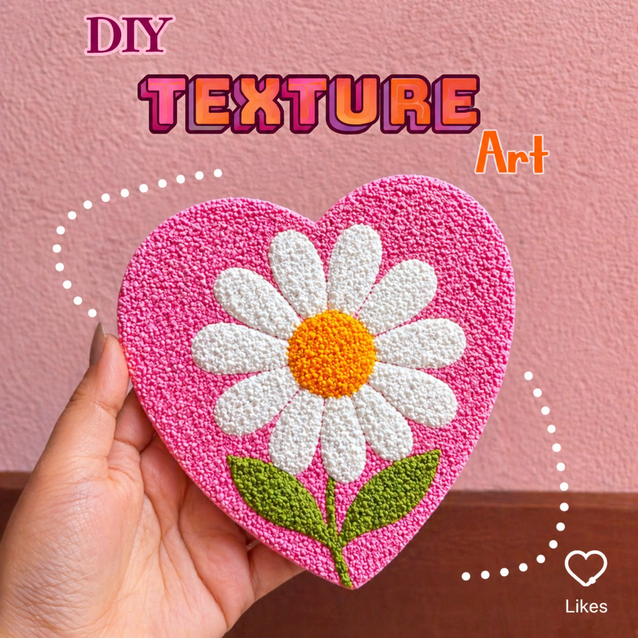 Heart-shaped DIY texture art with daisy flower on pink background. hand made paintings in karnal